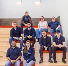 Outserve team sat on tiered bench seating