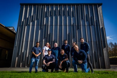 Outserve team in front of a Staffordshire university building