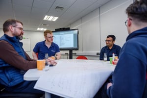 Outserve team working on a problem