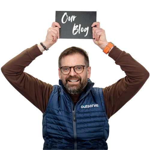 Our managing director Phil holds a sign saying 'our blog'